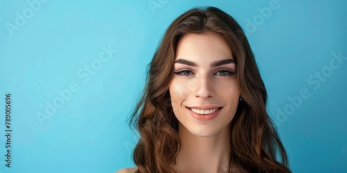 Place for text. Portrait of a beautiful young transgender girl, brunette on a blue background. Banner for advertising cosmetics, dentistry, piercing, hairdressing services, discounts and promotions