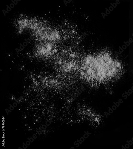 White powder isolated on black background, top view with clipping path. Close-Up Of White wheat flour Splashing Against dark Backdrop. dust powder splash clouds. cut out. row food ingredient