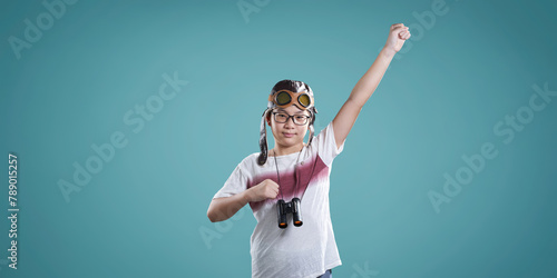 Young boy pretending to fly with aviator goggles and binoculars © jamesteohart