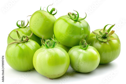 pile of green tomatoes isolated on white background