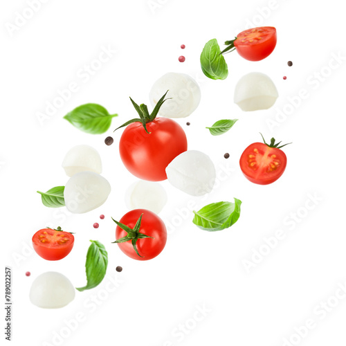 Flying mozzarella cheese balls, tomatoes, basil leaves and peppercorns for caprese salad isolated on white background. Mockup for advertising or product packaging design. Perfect retouched.