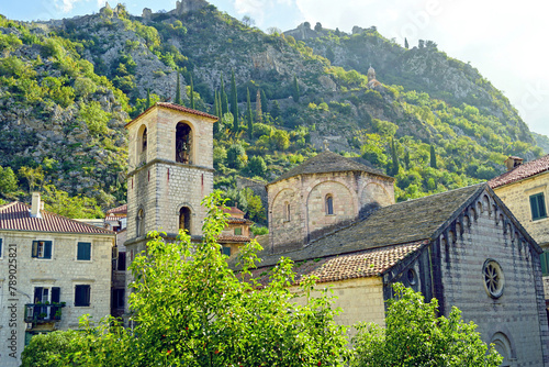 The Church of St. Mary of the River, in which the relics of Ozana of Kotor are kept - a view of the temple against the backdrop of the mountains on a sunny day (Kotor, Montenegro) photo