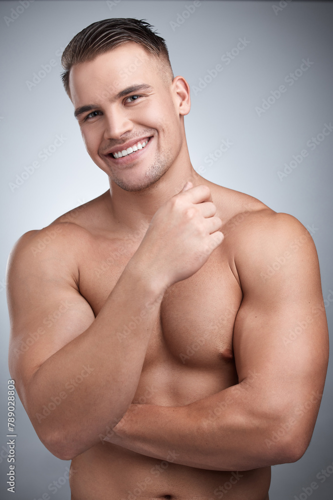 Fototapeta premium Man, muscular and portrait in studio for fitness, gym or workout for physical training or exercise. Model, smile and confident for bodybuilder with muscle growth or shirtless for wellness and abs