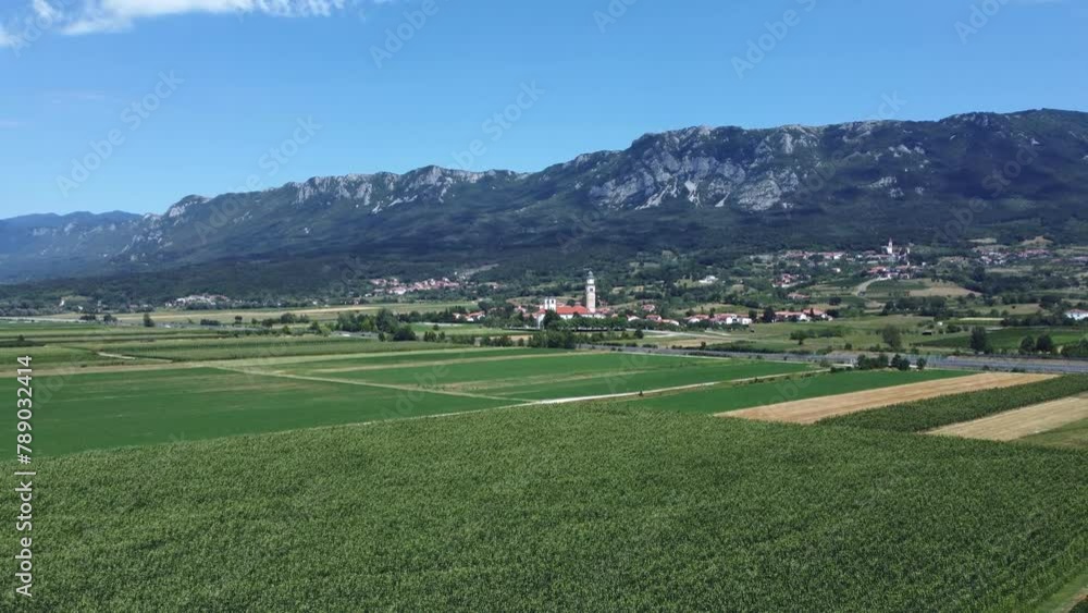 Drone pans right over Cerkev Matere Bozje, showcasing the lush Vipava vineyards. Drone pans right over Cerkev Matere Bozje, showcasing the lush Vipava vineyards.