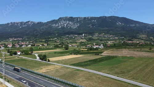 Drone shot capturing the expanse of Vipava Valley with highways amidst rolling hills and settlements photo