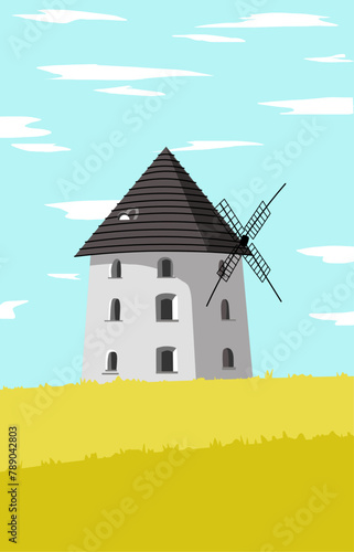 tower building with Windmill in the middle of the yellow meadow