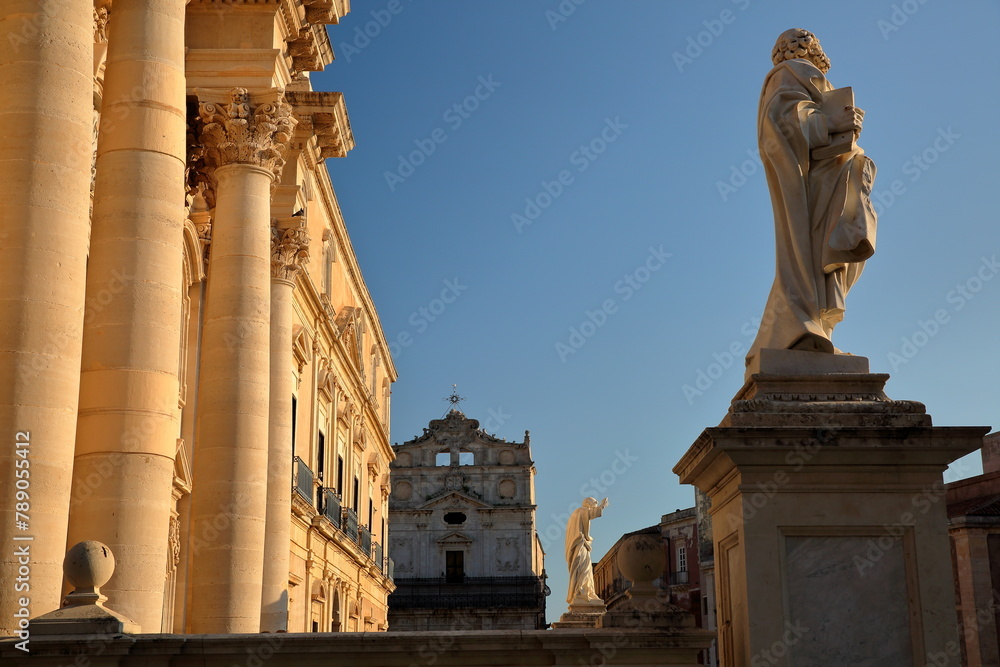 The sunset at Piazza del Duomo (Duomo Square), with the Duomo Cathedral and its columns on the left, Ortigia Island, Syracuse, Sicily, Italy