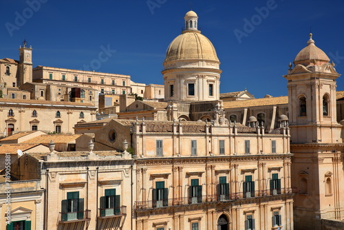Close-up on Basilica Minore di San Nicolo (Cathedral of St Nicholas), located on Piazza del Duomo (Duomo Square) in Noto, Syracuse, Sicily, Italy, with historical buildings photo