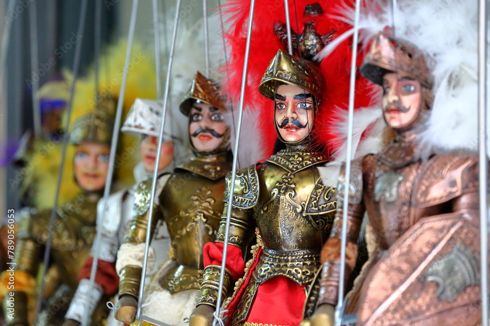 A row of traditional colorful Sicilian pupi (puppets) in Syracuse, Sicily, Italy, designed for theater performance