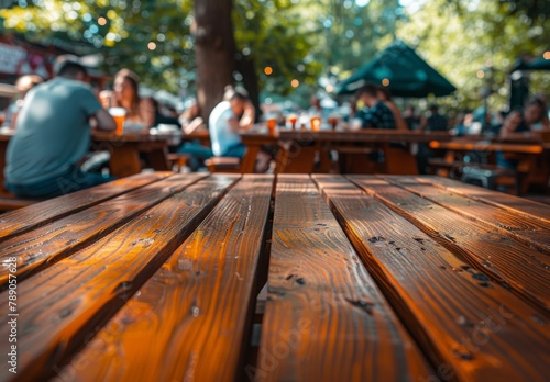 An outdoor cafe captures a trendy scene with people dining under the sun, while in the foreground, an empty wooden table suggests anticipation for gatherings