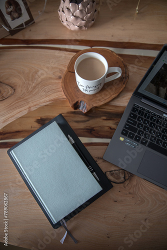 Wooden table with laptop and notepad for notes