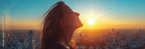 The woman opens her eyes and looks out at the view. The sun is now fully risen and the sky is a clear blue. The city below is just beginning to wake up.