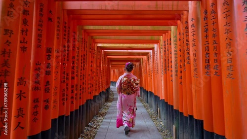 Slow motion video, Asian woman in traditional Japanese kimono at Fushimi Inari Shrine in Kyoto Japan