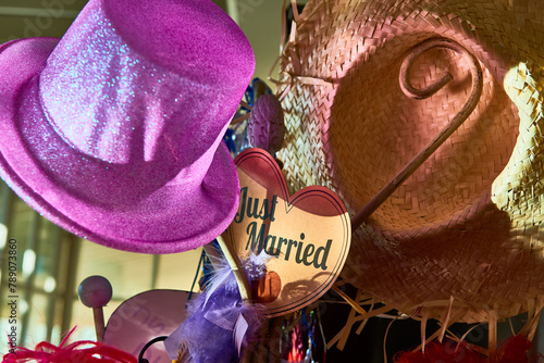pink party hat on a rack over a heart with the word just married