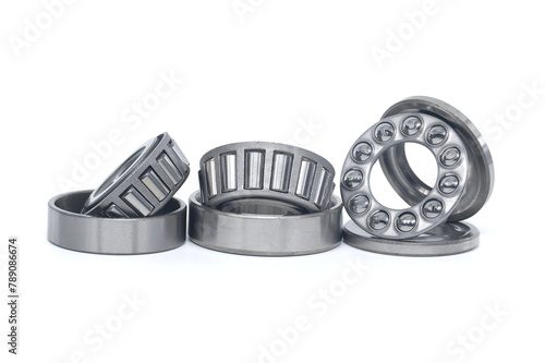 Tapered roller and thrust ball bearings isolated on white