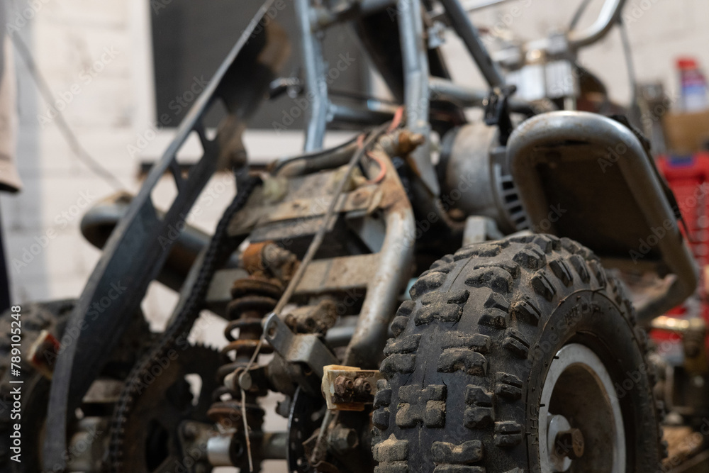 After completing the repair of the ATV the mechanic puts protection on it. Attaching protective shields to the ATV after completing engine repairs on the ATV. The concept of completing an ATV repair. After completing the repair of the ATV the mechanic puts protection on it. Attaching protective shields to the ATV after completing engine repairs on the ATV. The concept of completing an ATV repair.