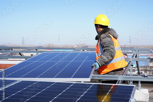 Workers install solar photovoltaic panels
