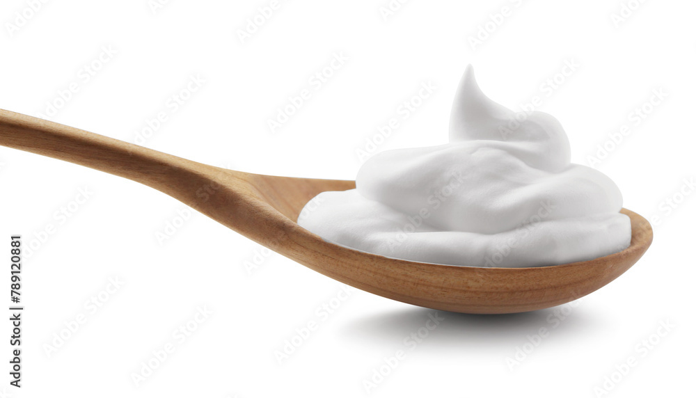 Wooden spoon with sour cream isolated on white Wooden spoon with sour cream isolated on white