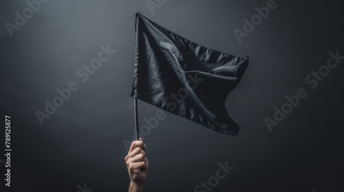 Creative angle of a hand holding a flag, fluttering with a sense of motion, against a starkly isolated background, high contrast studio lighting