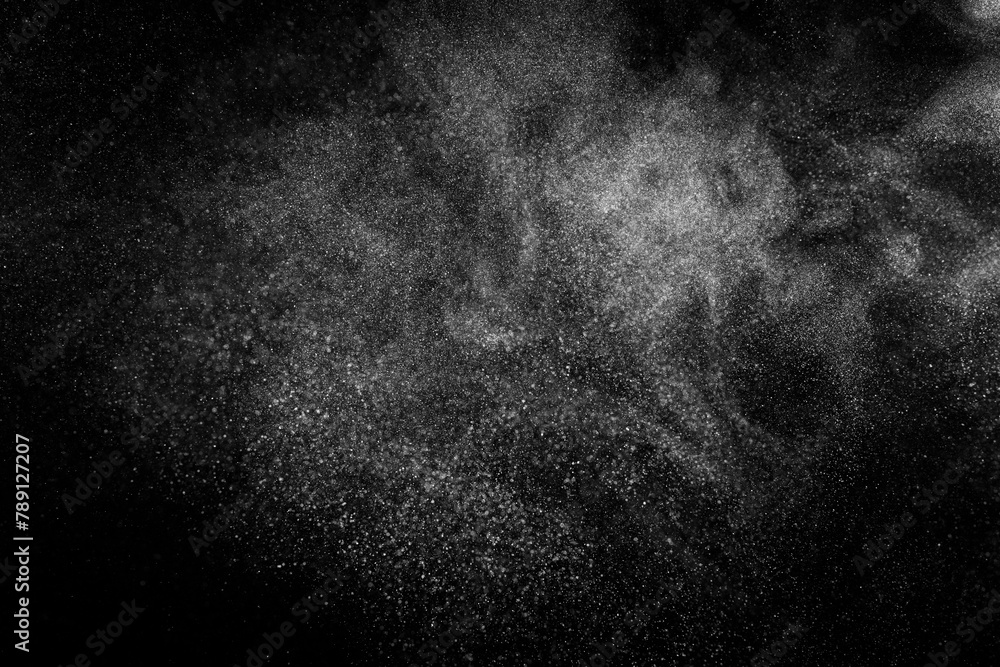 Obraz premium Abstract dust overlay texture. White particles on black background. Powder explosion. 