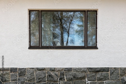 Brown framed window on a stone building.