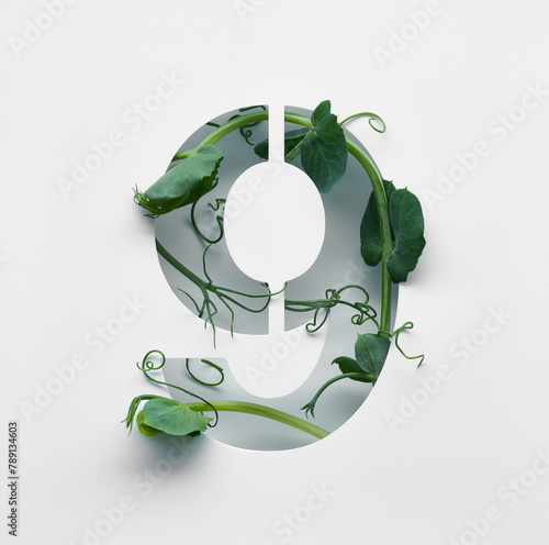 The number nine is made from young pea shoots on a white background.