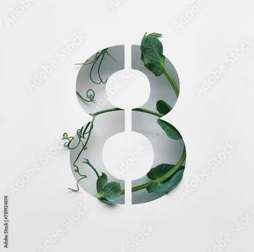 The number eight is made from young pea shoots on a white background.