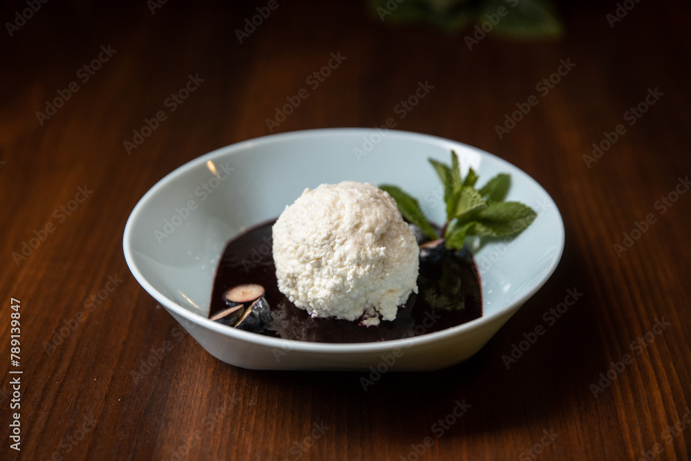 white ice cream with chocolate souce in white dish