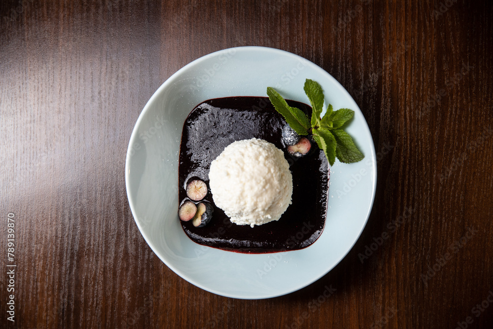 white ice cream with chocolate souce in white dish white ice cream with chocolate souce in white dish