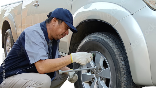 mechanic changing a wheel of a car