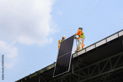 Worker installs solar panels. Worker installs solar panels at a solar farm field.