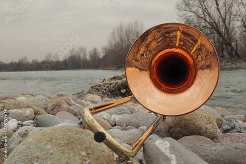 Trombone posing on trunk along Brembo river, Lombardy, Italy photo