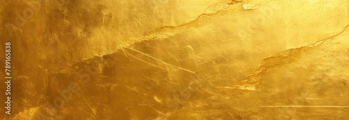 Gold metal texture background with scratches and cracks, shiny golden foil surface for luxury design or packaging decoration.