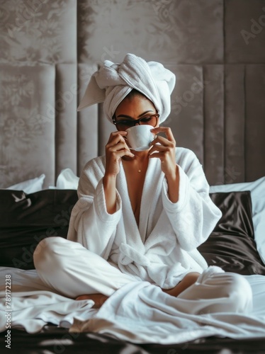 Woman Sitting on Bed With Towel Wrapped Around Head