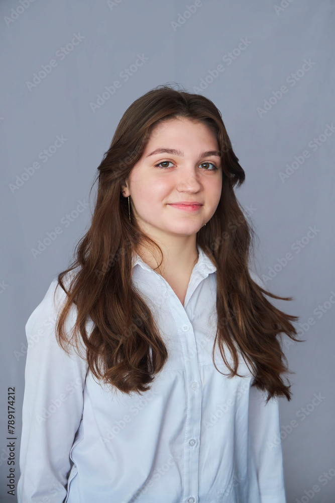 A high school student in uniform on a gray background. A high school student in uniform on a gray background.