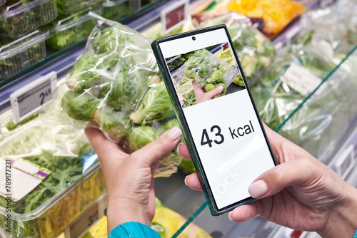 Checking calories on brussels sprout vegetable with smartphone © Sergey Ryzhov