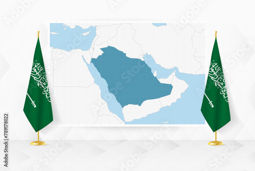 Map of Saudi Arabia and flags of Saudi Arabia on flag stand.