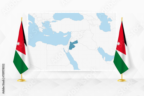 Map of Jordan and flags of Jordan on flag stand.