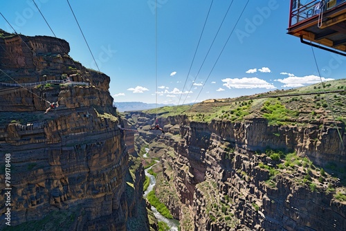 A daring individual bungee jumping from a towering bridge into a scenic gorge