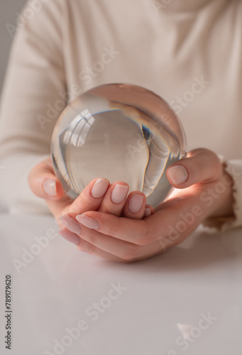 close up a person holds in hands glass ball