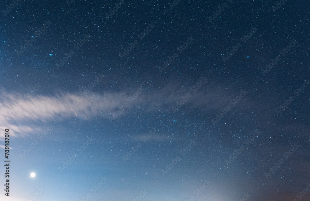 Fototapeta premium Natural Bold Blue Night Starry Sky Background. Bright Dramatic Sky. Night Starry Sky In Blue Colors. Calmness And Tranquility. Glowing Stars.