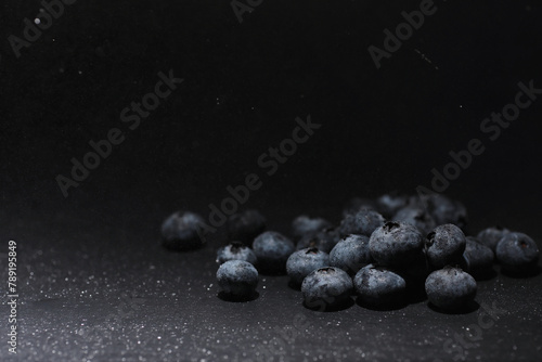 Water drops on ripe sweet blueberry. Fresh blueberries background with copy space for your text. Vegan and vegetarian concept. Macro texture of blueberry berries. © alexkich