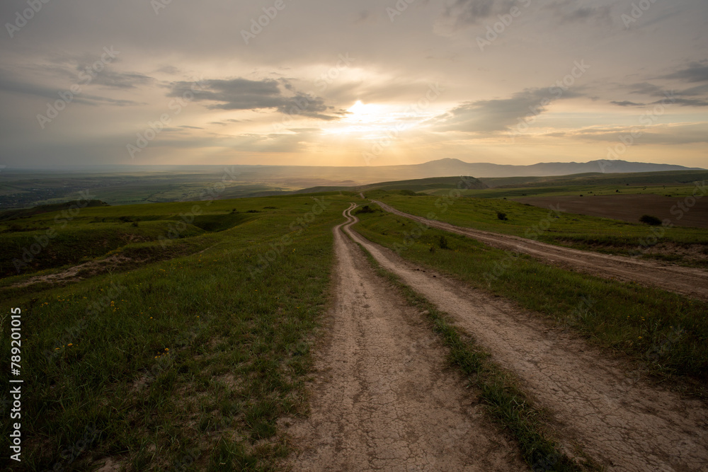 VIew of a road on the mountains during sunset VIew of a road on the mountains during sunset