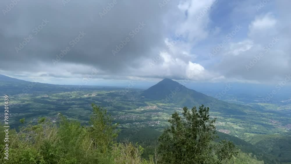 Landscape Timelapse of Mount Andong (Grabag, Magelang, Jawa Tengah, Indonesia) with a lot of clouds, green scape, villages, trees, forest etc. Taken from the peak of Mt. Telomoyo (Ngablak, Magelang) Landscape Timelapse of Mount Andong (Grabag, Magelang, Jawa Tengah, Indonesia) with a lot of clouds, green scape, villages, trees, forest etc. Taken from the peak of Mt. Telomoyo (Ngablak, Magelang)