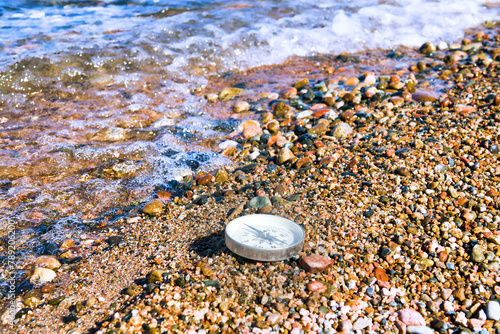 The right compass is always needed for travelers, adequate course. Hiking on the shore of Lake Baikal in Siberia photo