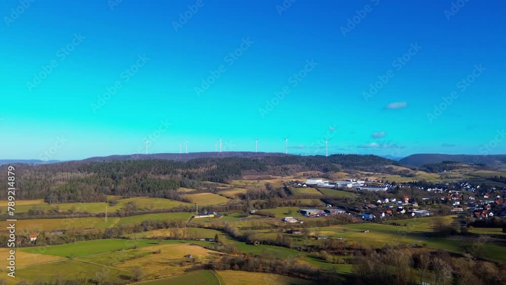 Sustainable Future: Wind Turbines Overlook a Thriving Countryside Village Sustainable Future: Wind Turbines Overlook a Thriving Countryside Village