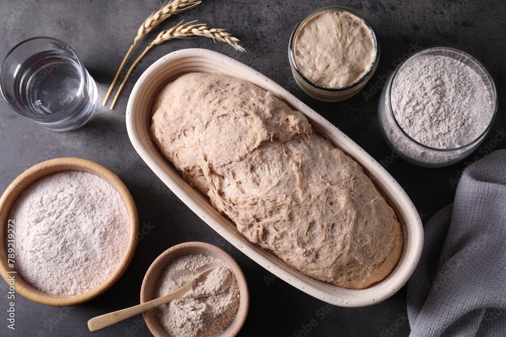 Fresh sourdough, flour, water and spikes on grey table, flat lay Fresh sourdough, flour, water and spikes on grey table, flat lay