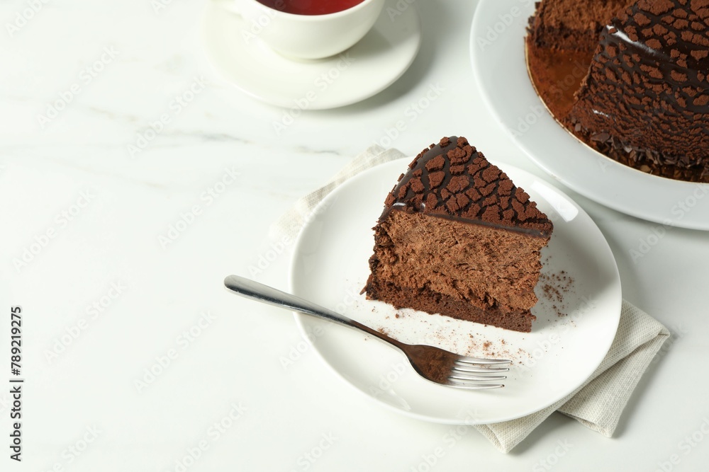 Piece of delicious chocolate truffle cake on white marble table, space for text Piece of delicious chocolate truffle cake on white marble table, space for text