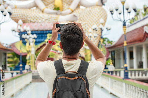 Photography Tourist Capturing Temple Statue with Smartphone