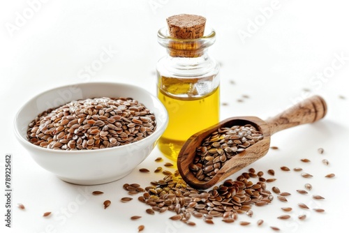 Flaxseed Oil in a Bottle and Bowl with Brown Seeds and Wooden Spoon on White Background. Perfect for Medicals and Cookery